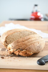 Homemade sour dough bread wrapped in cotton tea towel and sliced