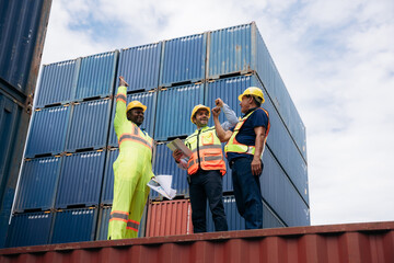 Team worker stack hand and shake hands to show success work at Container cargo harbor. Logistics concept inside the shipping, import, and export industries.