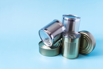 Cans with various products in close-up on a colored background. Long-term storage products.
