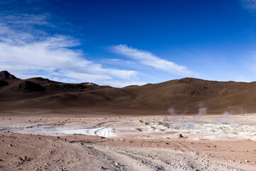 Fototapeta na wymiar Stunning geothermic field of Sol de Mañana with its steaming geysers and hot pools with bubbling mud - just one sight on the lagoon route in Bolivia, South America