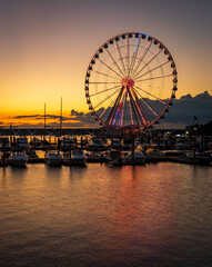 Illuminated ferris wheel at National Harbor near the nation capital of Washington DC at sunset with...