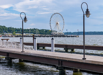 Wooden pier with the Ferris Wheel behind with skyline of National Harbor near Washington DC
