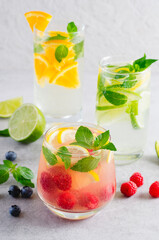 Summer Drinks Set, Fruit, Citrus and Berry Refreshing Lemonade or Cocktails on Bright Background