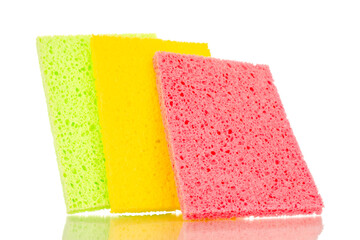 Three colored cellulose kitchen sponges, macro, isolated on white background.