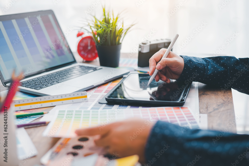 Fototapete Graphic designer architects who work with laptops and color comparison tables for design work..
