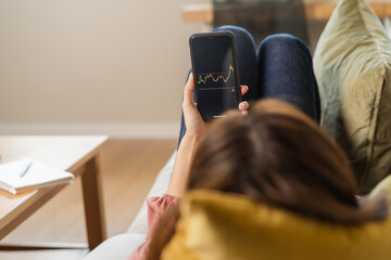 Investor analyzing exchange market, asian young business woman, girl trader on graphic charts on tablet, smartphone for trading stock, looking at screen with diagrams at home office. Start up people.