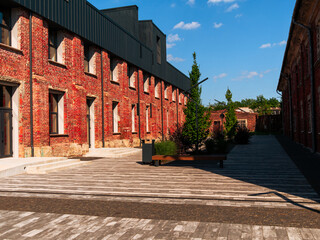 Modern cafe workspace exterior loft style red brick wall Old industrial building renovation. Creative urban space Break-out area city loft conversion brickwork warehouse design floor-to-ceiling window