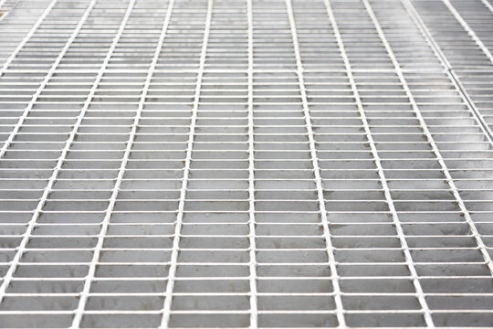 A Background Image Of A Corridor Built From Gray Steel Grating Panels.