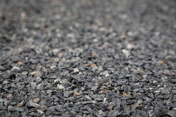 Wallpaper picture of gray granite pebbles floor with a blurred background for graphic design work