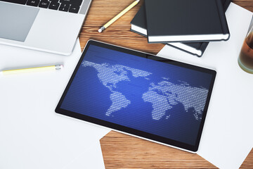 Modern digital tablet display with abstract creative world map, globalization concept. Top view. 3D Rendering