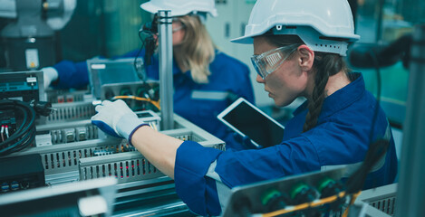 Two Females engineers using tablet Working  check in workshop.