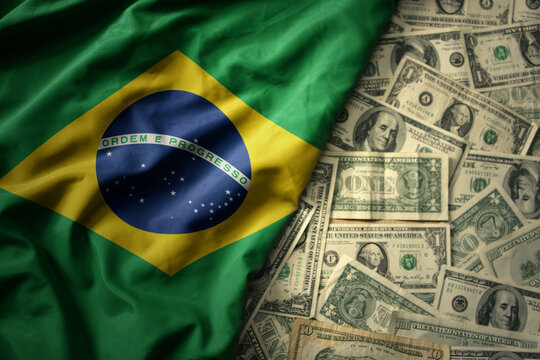 colorful waving national flag of brazil on a american dollar money background. finance concept