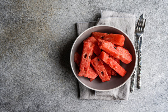 Watermelon in a bowl on concrete background