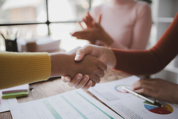 Fototapeta premium Business investor group shakes hands, Two businessmen are agreeing on business together and shaking hands after a successful negotiation. Handshaking is a Western greeting or congratulation.