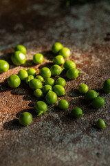 Fresh green peas on stone surface.