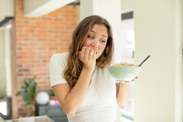 pretty woman feeling scared, worried or angry and looking to the side. breakfast bowl concept
