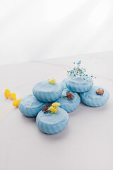 Handmade light blue soap with flowers on fabric, close-up