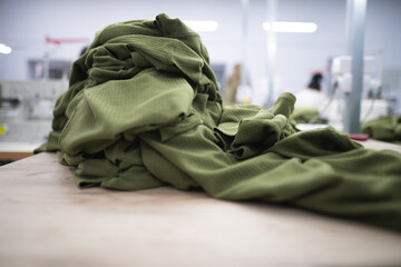 a pile of sewn heat sink clothes on a table in a sewing factory