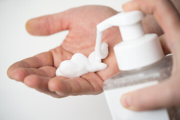 applying and rubbing the cosmetic product from the bottle into the hand