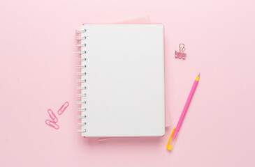 Notebooks with pen on color background, top view