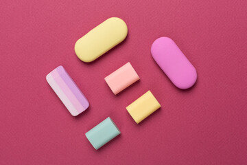 Colorful eraser on color backgroung, top view