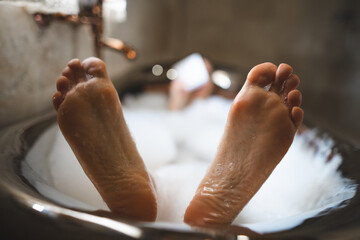 funny close up photo of feet in bubble bath