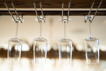 empty clean glass glasses for alcoholic drinks in a restaurant on a bar counter