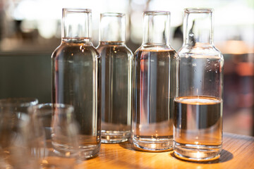 empty clean glass decanters for water in a restaurant on a bar counter