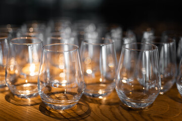 empty clean glass glasses for alcoholic drinks in a restaurant on a bar counter
