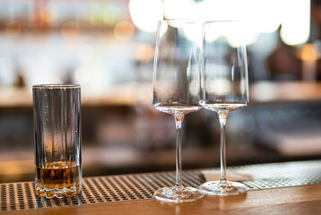 empty clean glass glasses for alcoholic drinks in a restaurant on a bar counter