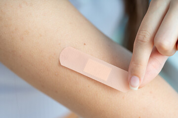 woman putting a band-aid