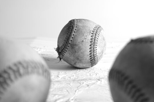Nostalgic sports image of old used baseballs from vintage equipment in black and white.