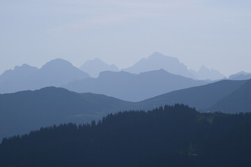 Blue mountain ranges in the morning light seen from Vorder Walig, Switzerland.