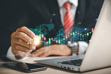 Trader's hand with a digital pen points to a virtual hologram stock on a smartphone, symbolizing stock market progress and business growth. Invest in trading with planning and strategy.