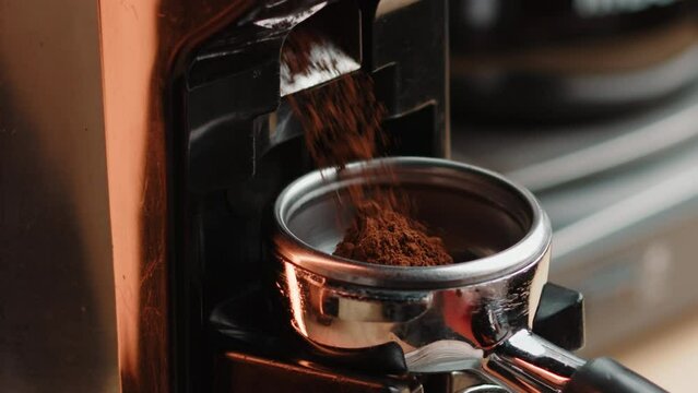 Professional barista worker use grinder machine to grind fresh coffee beans for make hot beverage cafe table. Extreme close up macro shot - Powered by Adobe