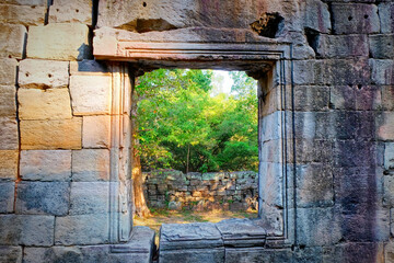 A square empty window in an old stone wall.