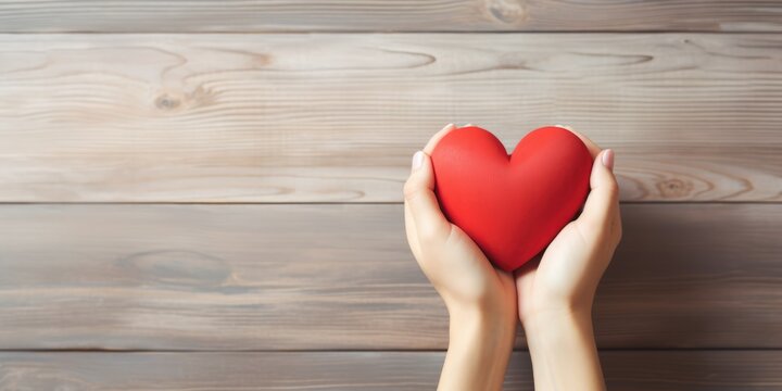 Young women hands holding red heart on wood background, health care, donate and family insurance concept, world heart day, world health day, CSR responsibility, adoption foster family, generative ai