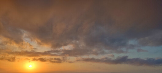 Sunset sky background with clouds. Beauty bright air background. Gloomy vivid cyan landscape.