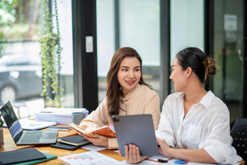 Two colleague businesswoman are meeting online, marketing plan, business plan, checking statistics and accounting.