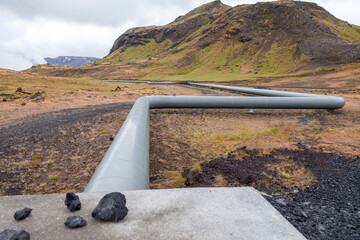 geothermal energy pipelines running along the desert hills of iceland