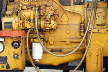 Close up a yellow engine of the generator  in the park.