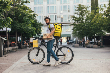 delivery man working in the city with his bike looking for the street to deliver a package