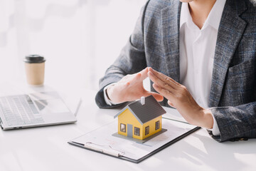 Real estate agent and customer signing contract to buy house, insurance or loan real estate.rent a house,get insurance or loan real estate or property.