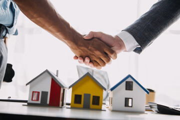 Real estate agent and customer signing contract to buy house, insurance or loan real estate.rent a house,get insurance or loan real estate or property.