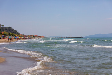 Sea waves with foam rolling onto the shore