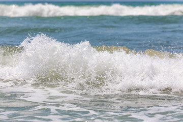 A wave coming ashore with splashes
