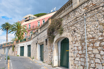 Fototapeta na wymiar Taormina, Italy, Sicily, old town, bars, alleys, old facades, stairs with a Mediterranean flair