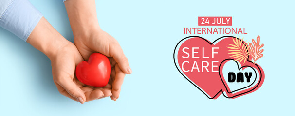 Banner for International Self Care Day with hands holding red heart