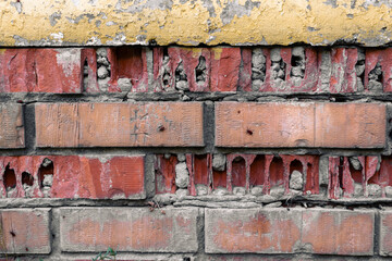 Broken brick wall. Texture of brown cracked brick