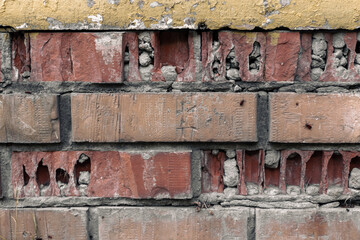 Broken brick wall. Texture of brown cracked brick